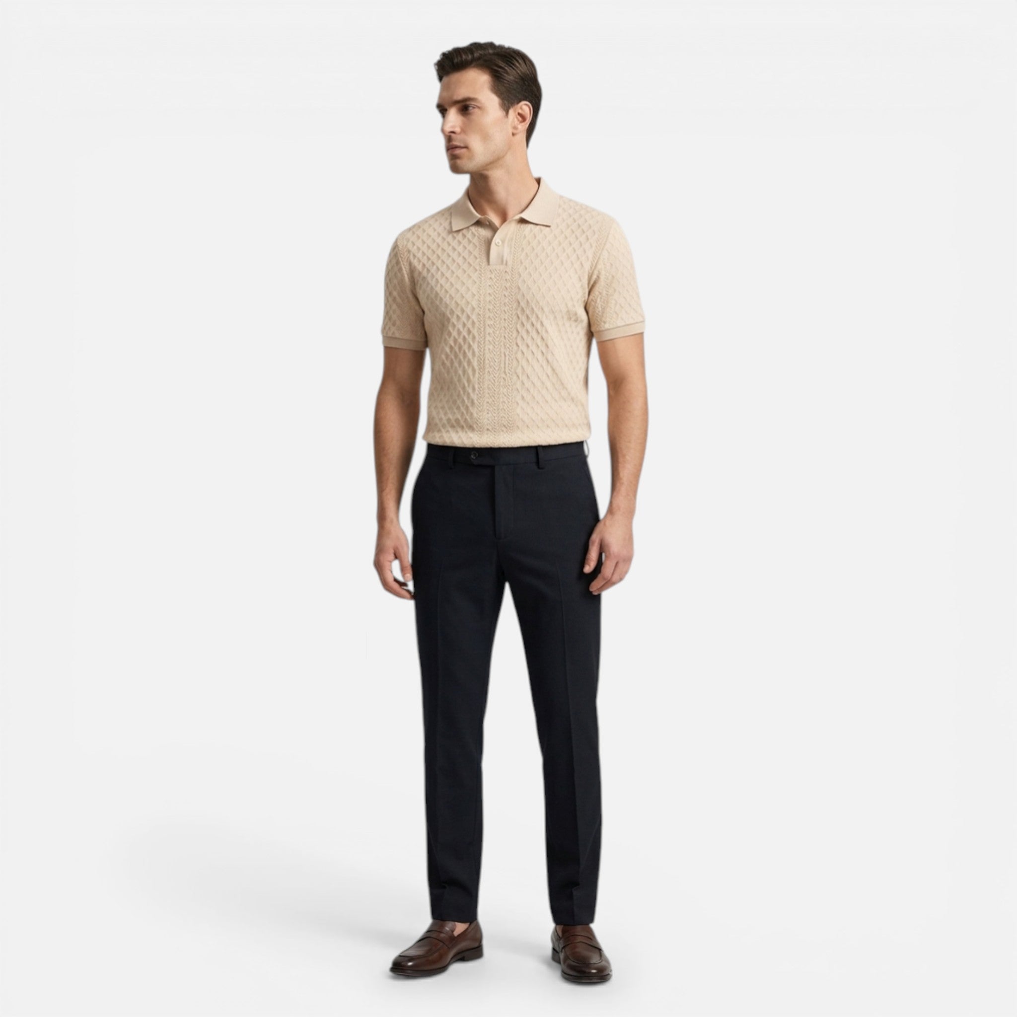 Man wearing a beige patterned polo shirt and black pants on a white background