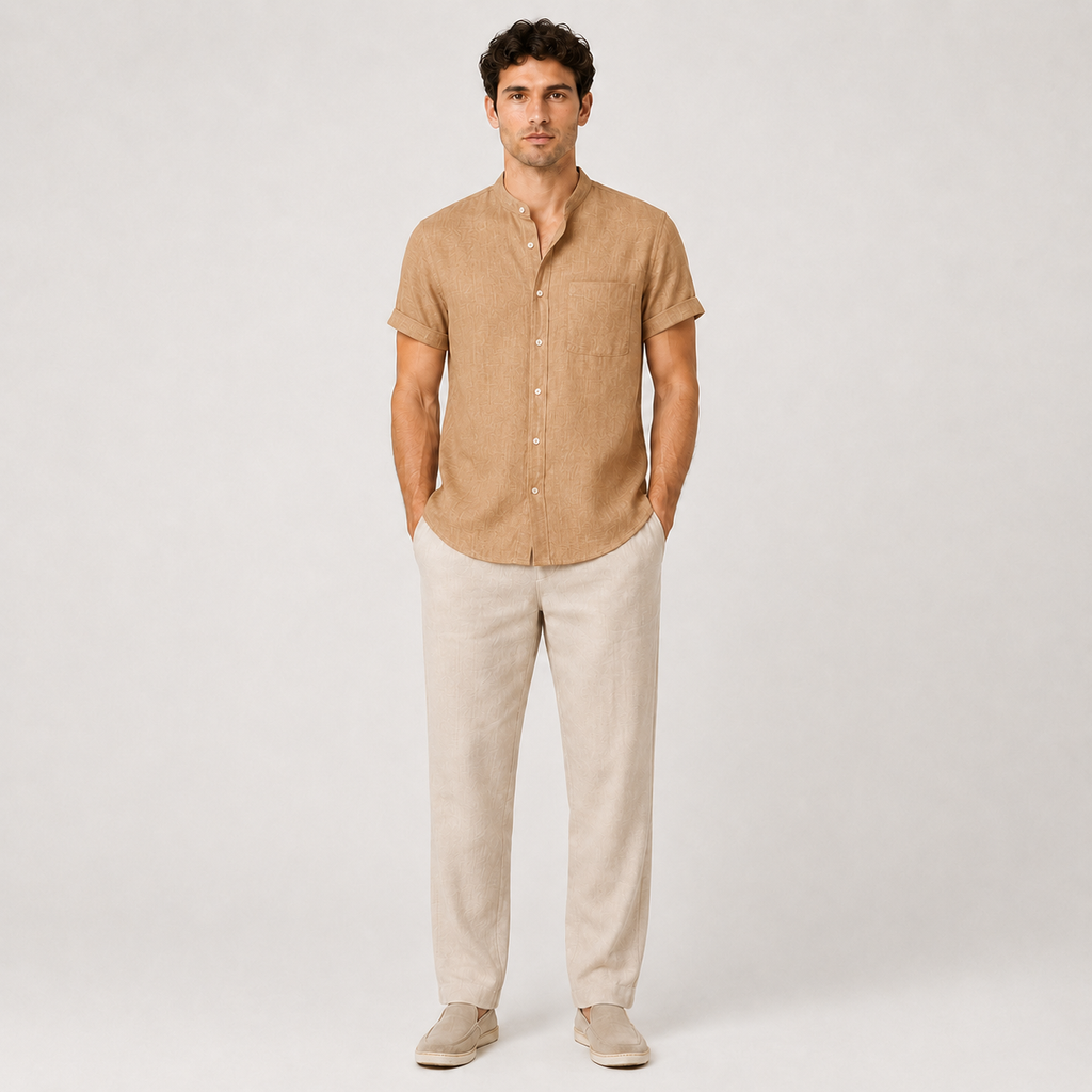 Man wearing a beige short-sleeve shirt and light-colored pants on a white background