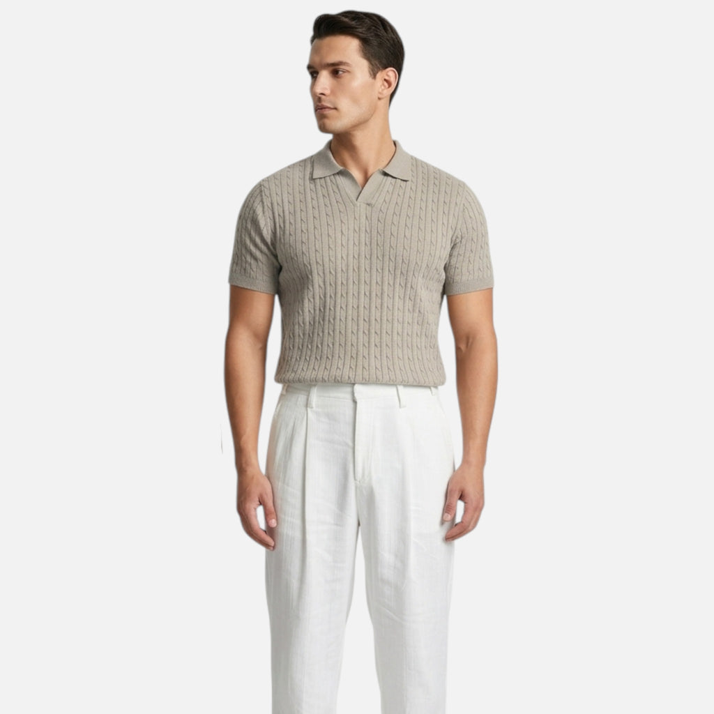 Man wearing a beige textured polo shirt and white pants on a white background