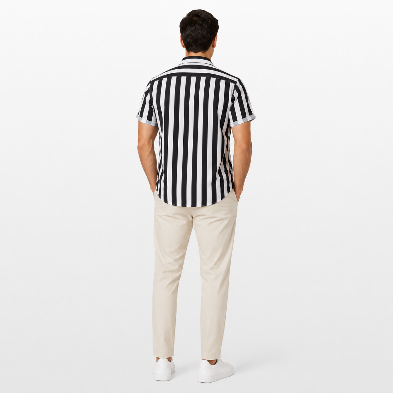 Man wearing a black and white striped shirt and beige pants on a white background