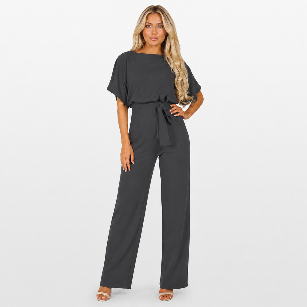 Woman wearing a black jumpsuit on a white background