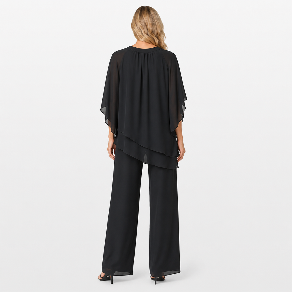 Woman wearing a black layered outfit on a white background