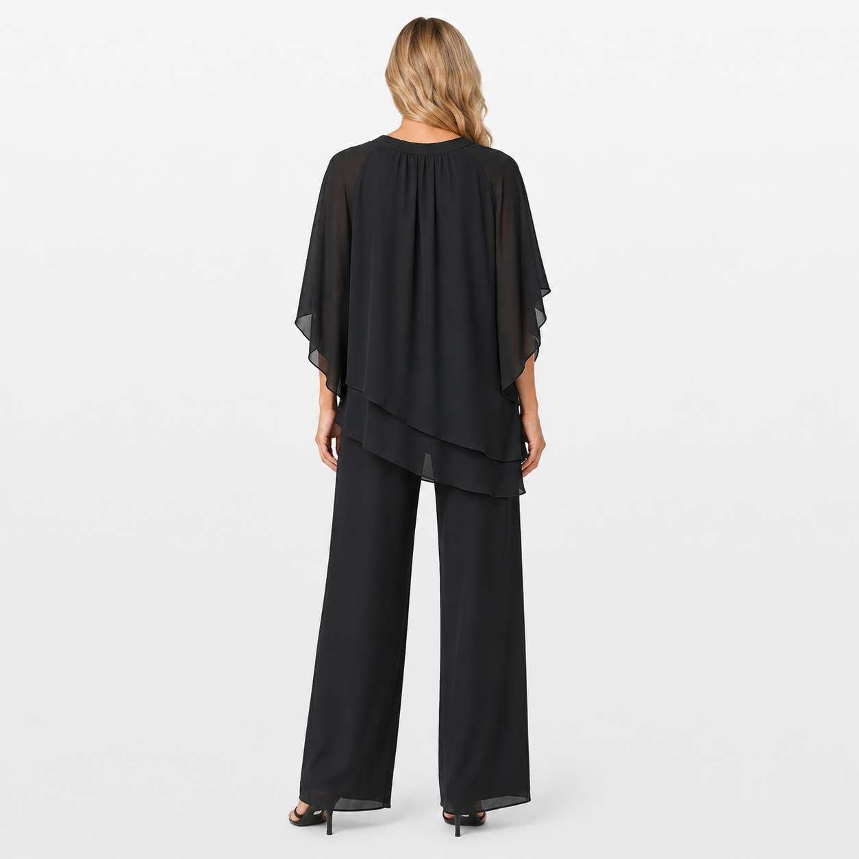 Woman wearing a black layered outfit on a white background