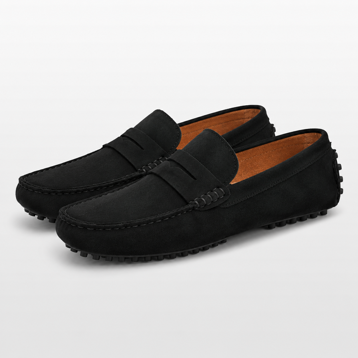 Pair of black loafers on a light gray background
