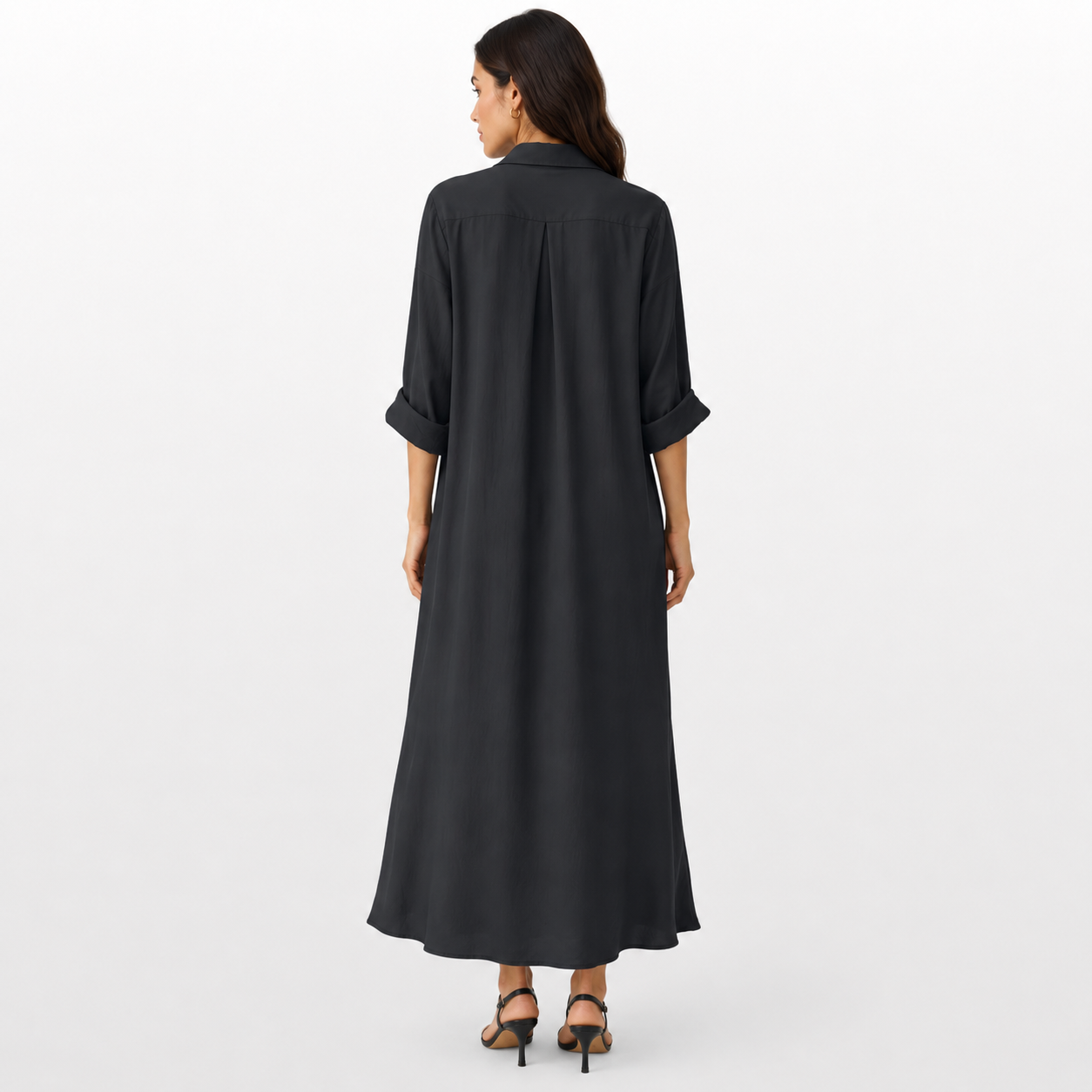 Woman wearing a black long dress on a white background