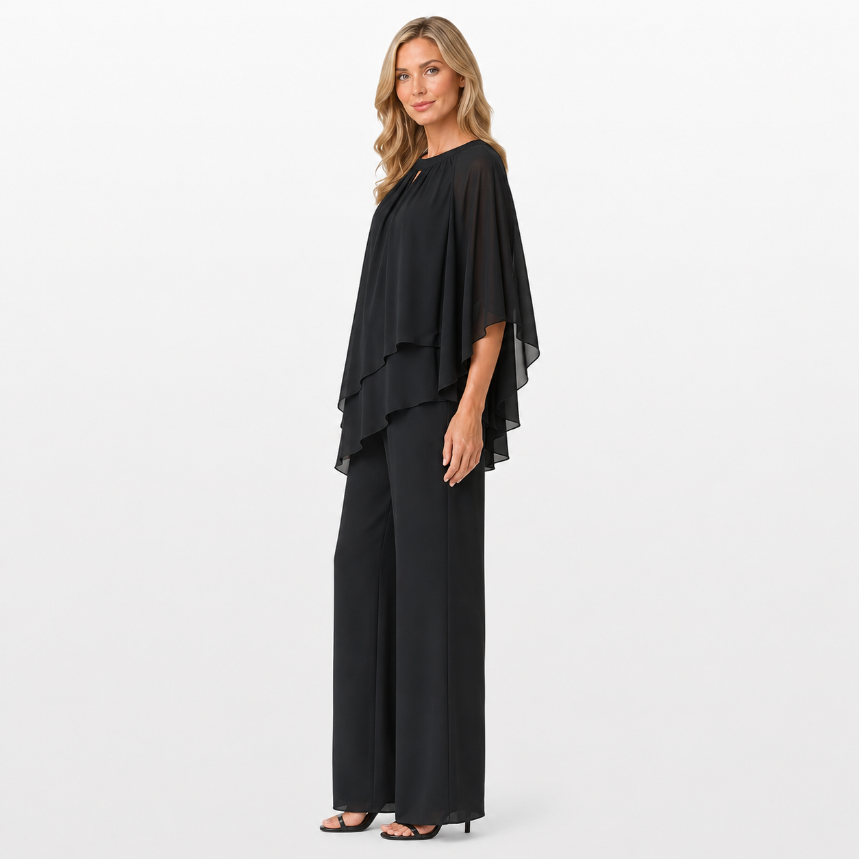 Woman wearing a black outfit with a layered top and wide-leg pants on a white background