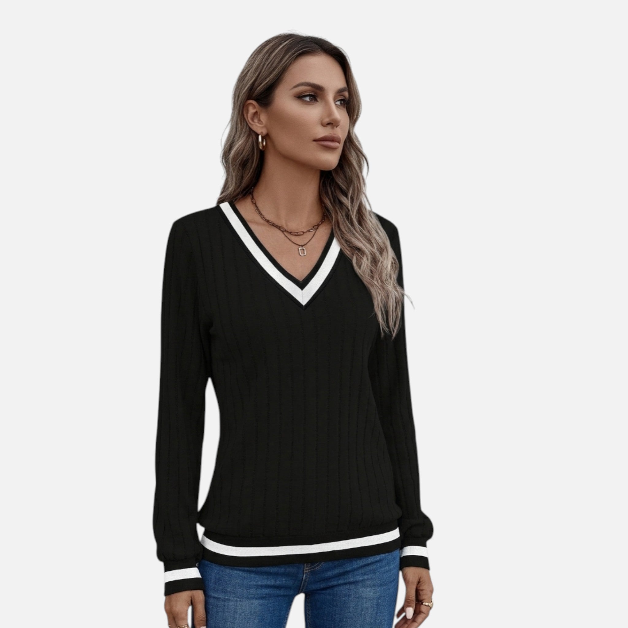 Woman wearing a black sweater with white trim on a white background