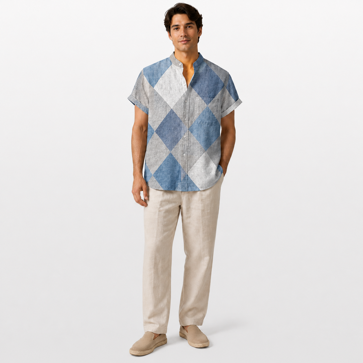 Man wearing a blue and gray checkered shirt with beige pants on a white background