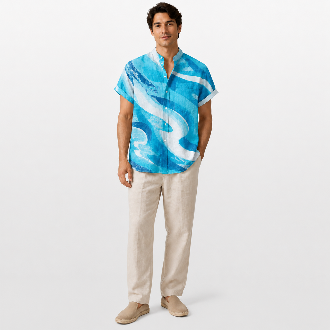 Man wearing a blue and white patterned shirt with beige pants on a white background