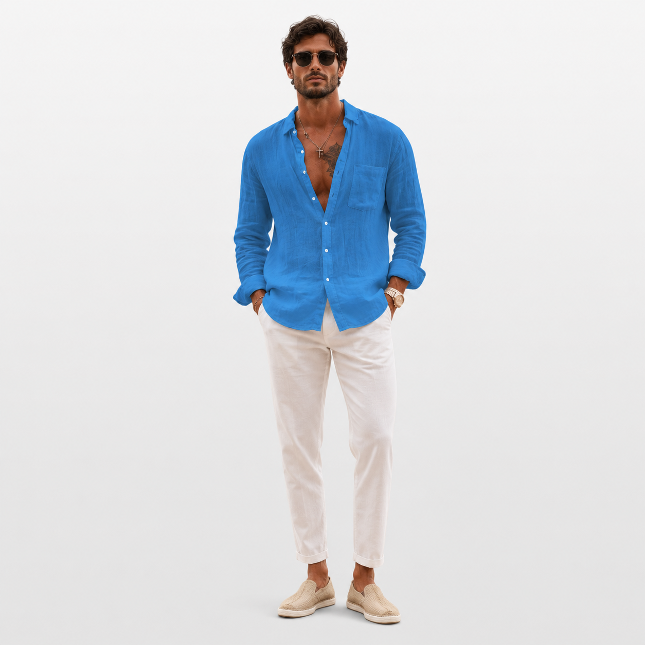 Man wearing a blue shirt and white pants on a light gray background