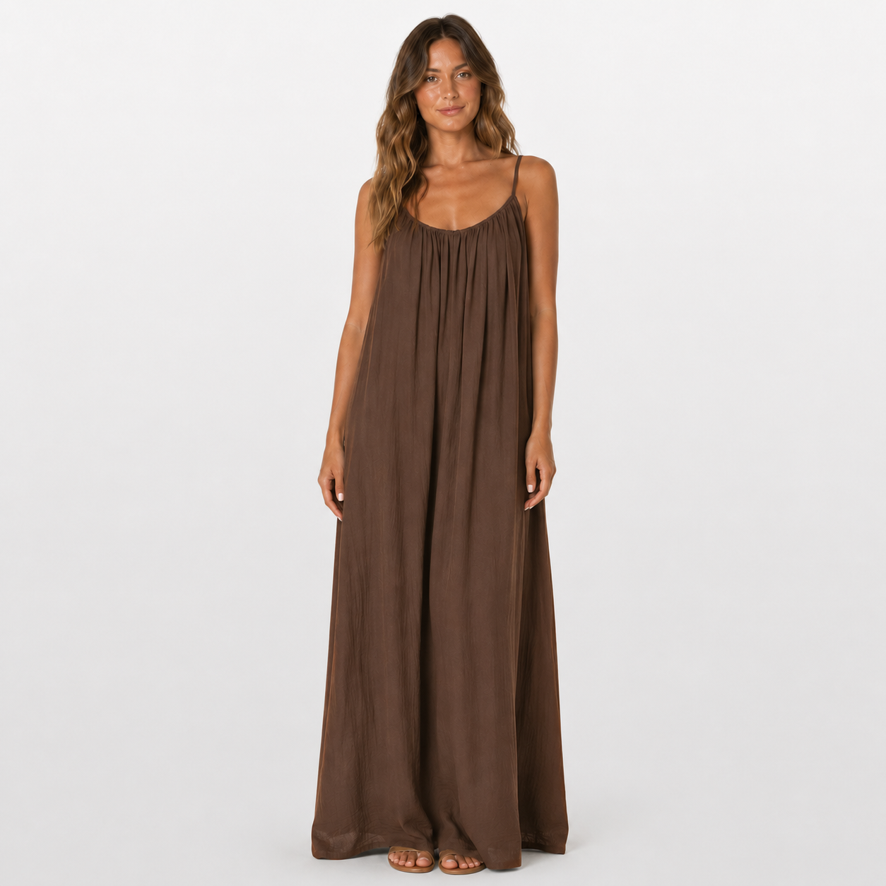Woman wearing a brown maxi dress on a white background
