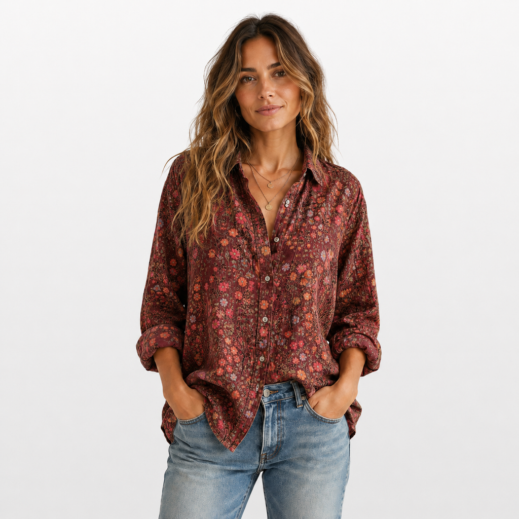 Woman wearing a patterned shirt and jeans on a white background
