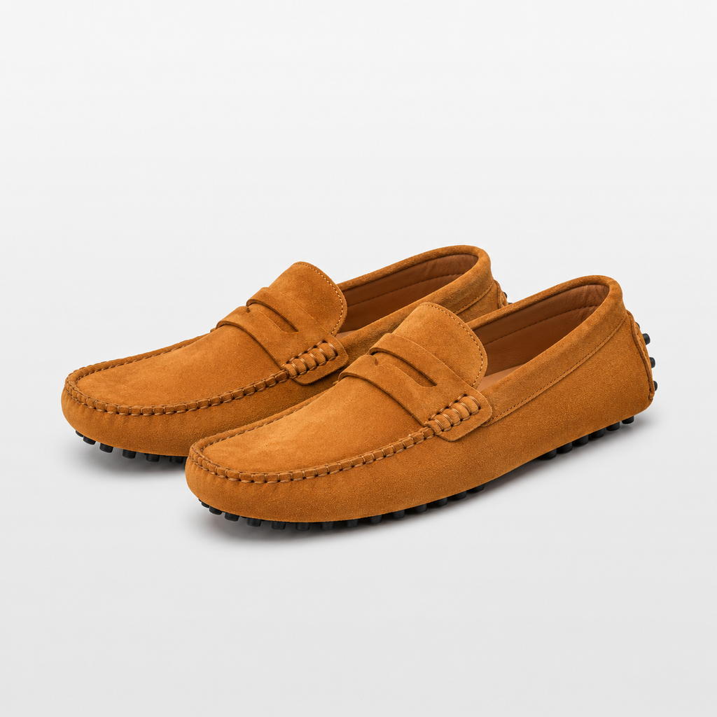 Pair of brown suede loafers on a light gray background
