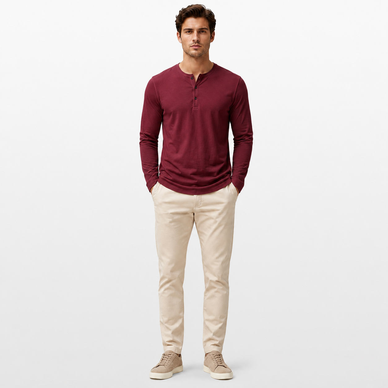 Man wearing a burgundy long-sleeve shirt and beige pants on a white background