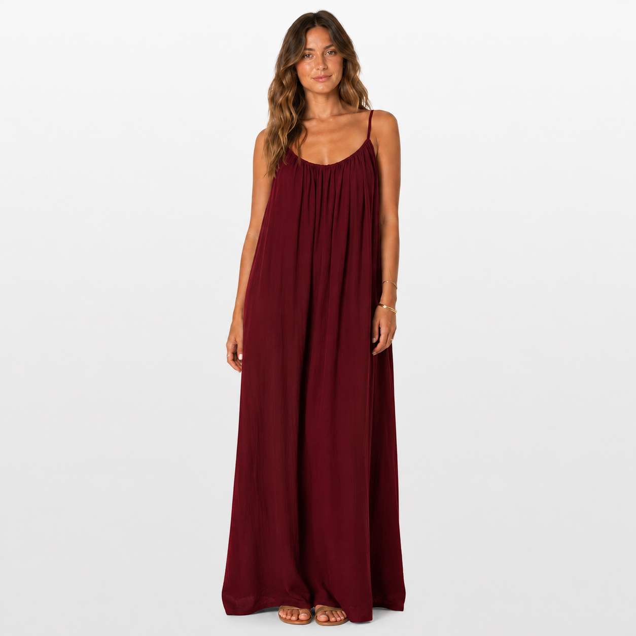 Woman wearing a burgundy maxi dress on a white background