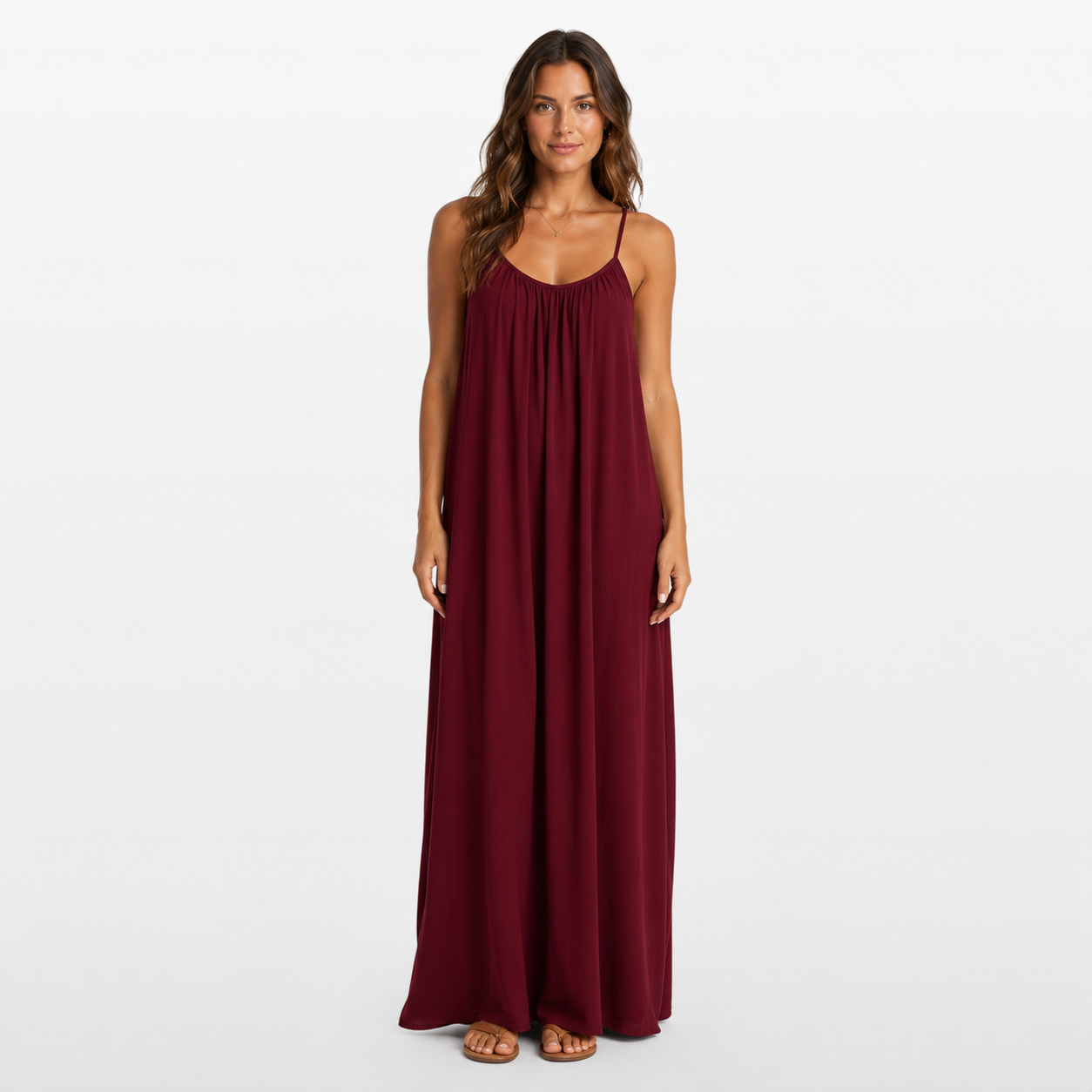 Woman wearing a burgundy maxi dress on a white background