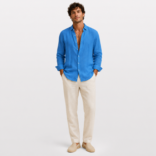 Man wearing a blue shirt and beige pants on a white background