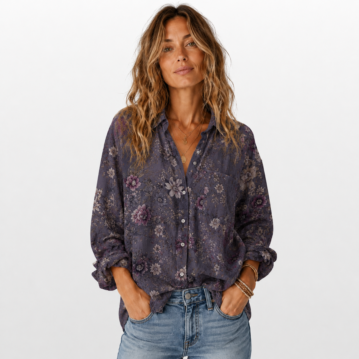 Woman wearing a floral blouse and jeans on a white background
