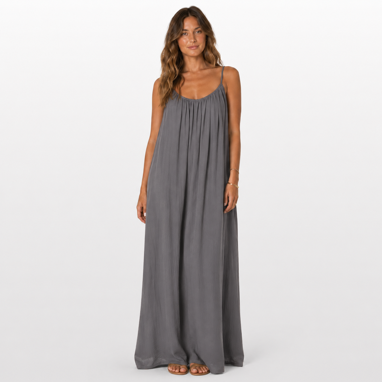 Woman wearing a gray maxi dress on a white background
