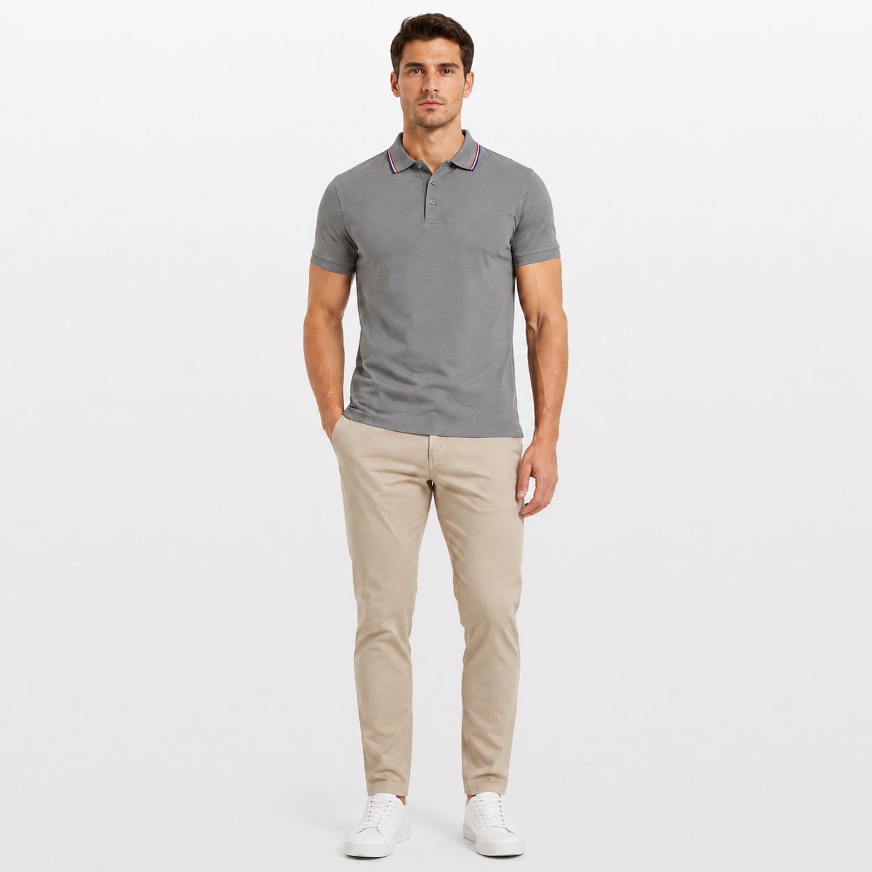 Man wearing a gray polo shirt and beige pants on a white background