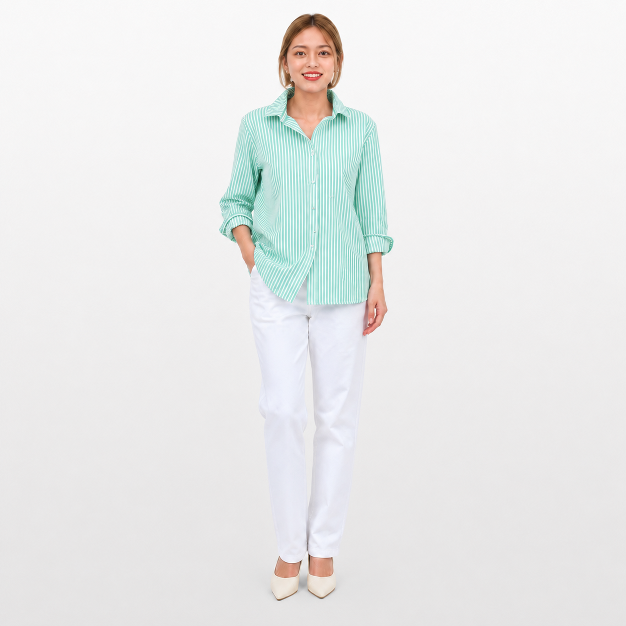 Woman wearing a light green checkered shirt and white pants on a white background