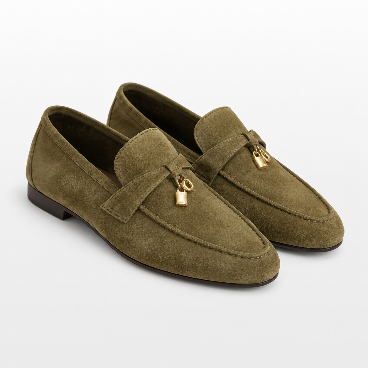 Pair of green loafers with a gold buckle on a white background