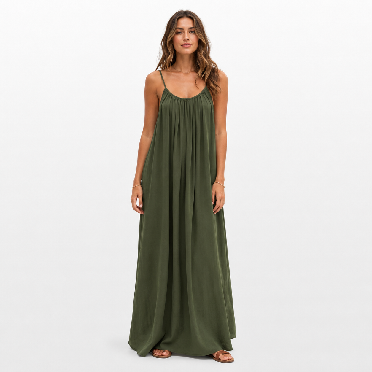 Woman wearing a green maxi dress on a white background