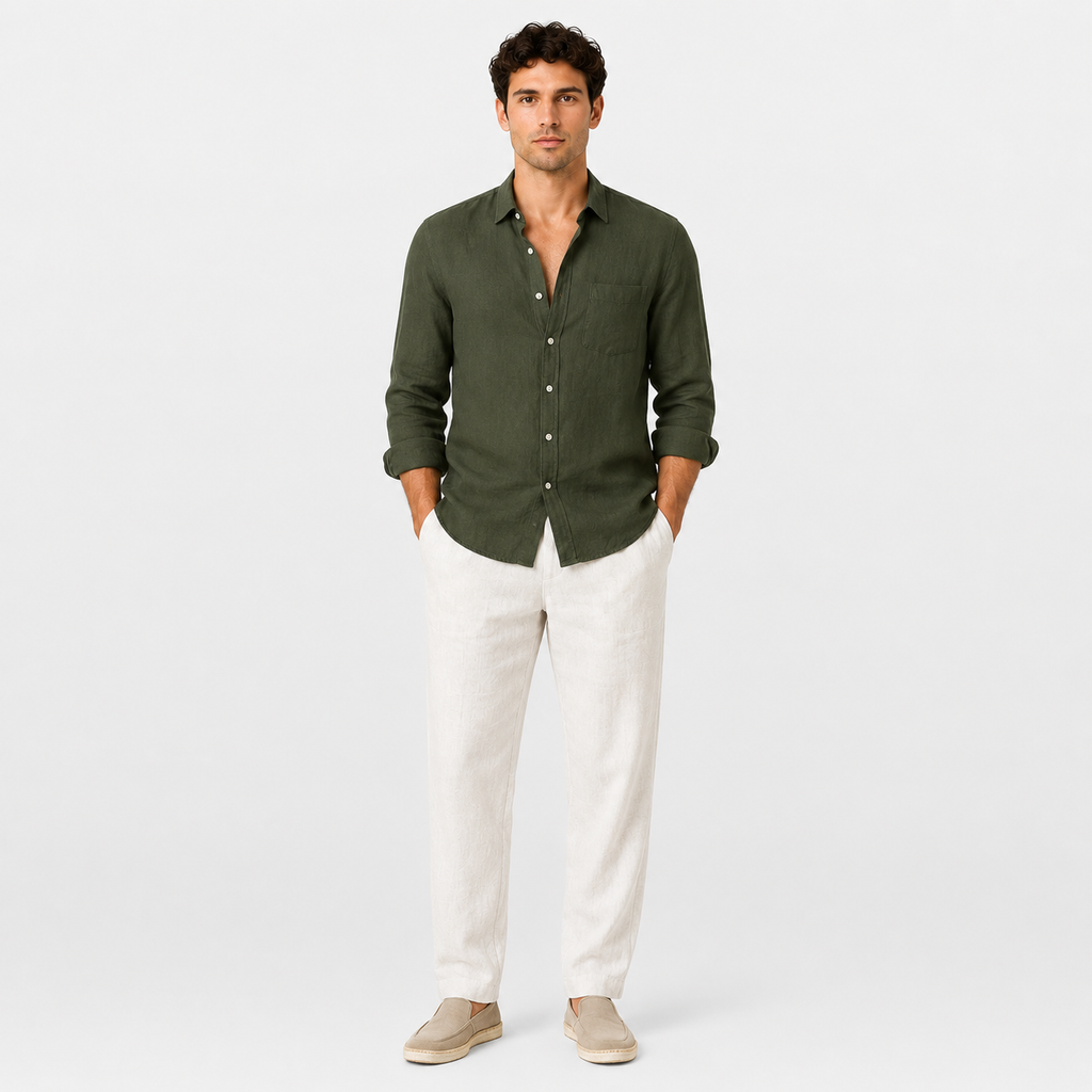 Man wearing a green shirt and white pants on a white background