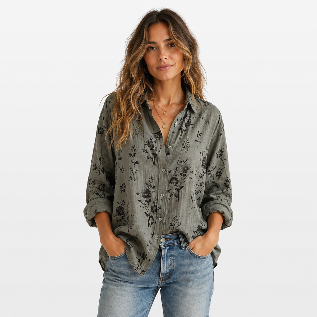 Woman wearing a floral patterned shirt and jeans on a white background