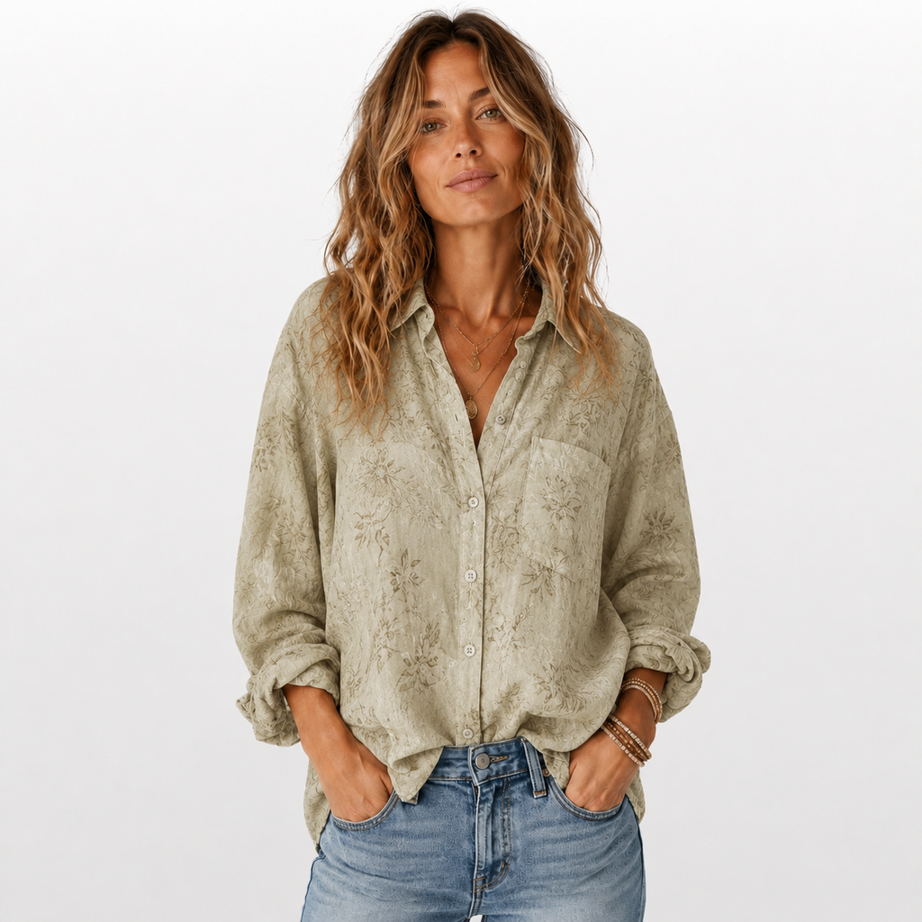 Woman wearing a patterned shirt and jeans on a white background
