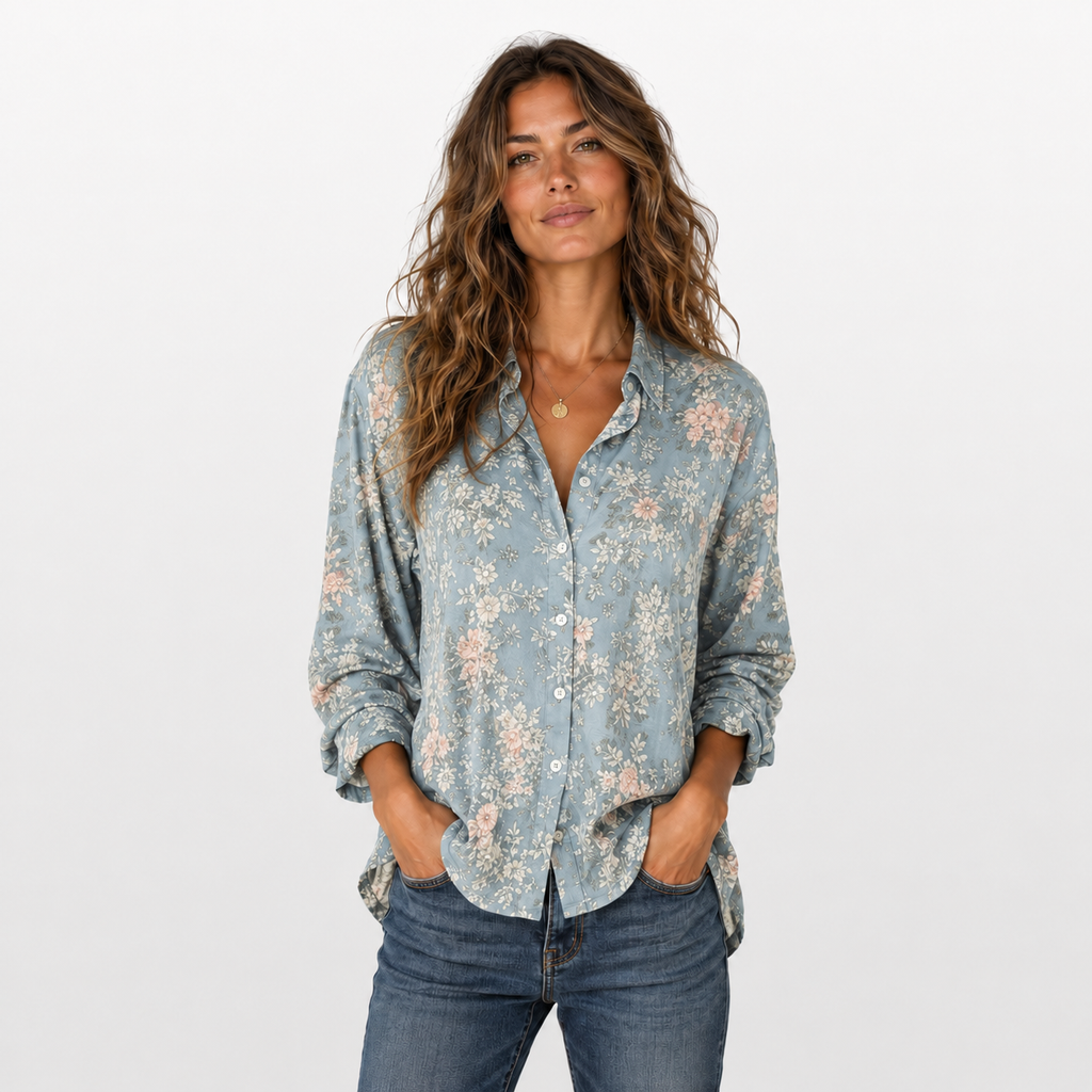 Woman wearing a floral blouse and jeans on a white background