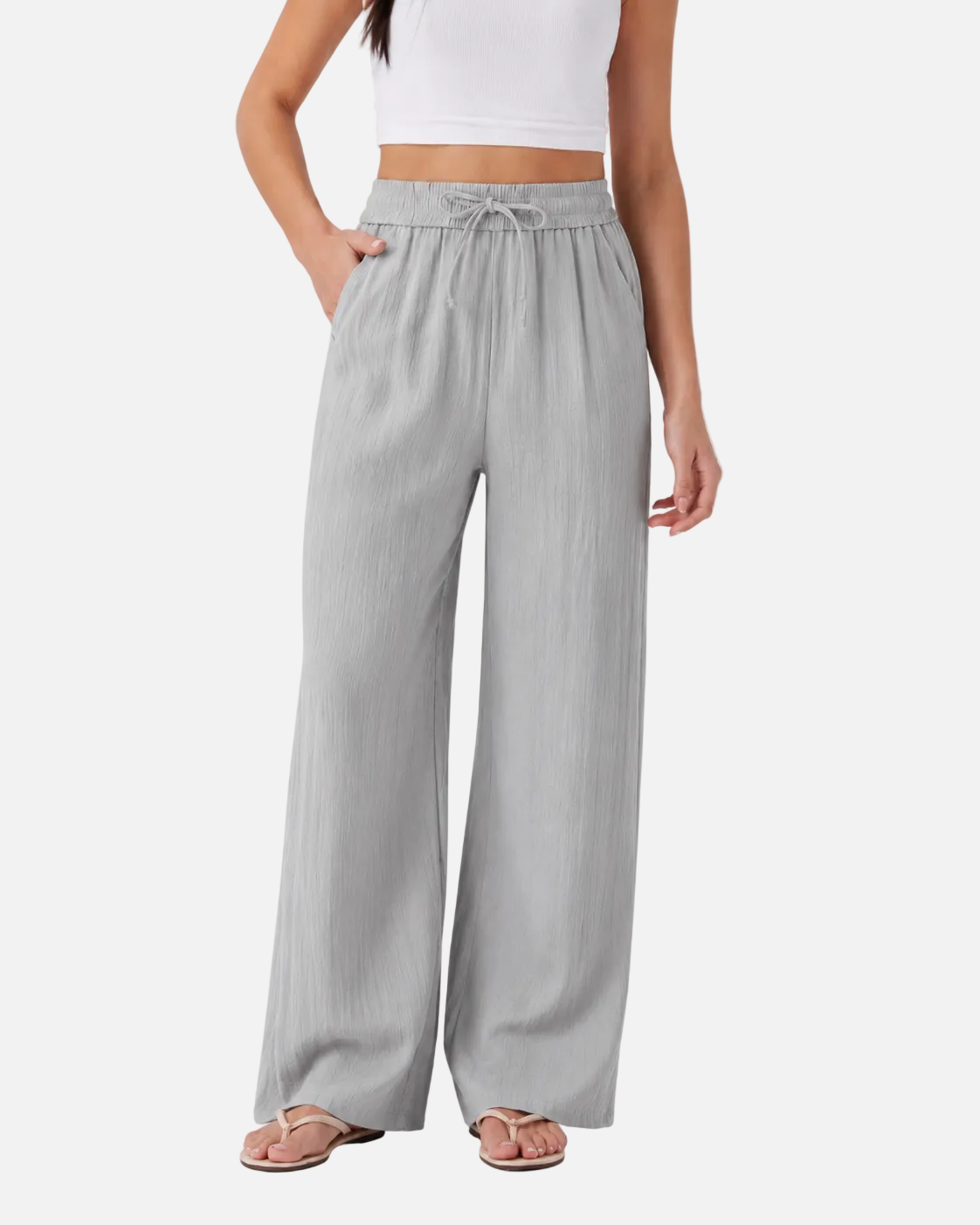 Woman wearing light gray wide-leg pants on a white background