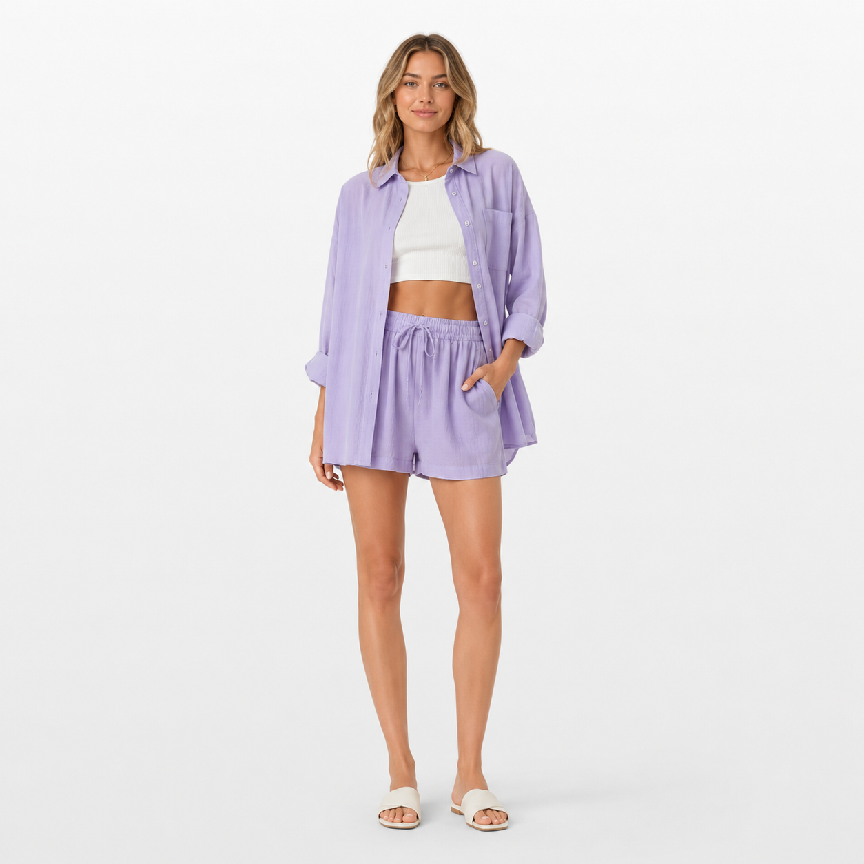 Woman wearing a light purple outfit with shorts and a shirt on a white background