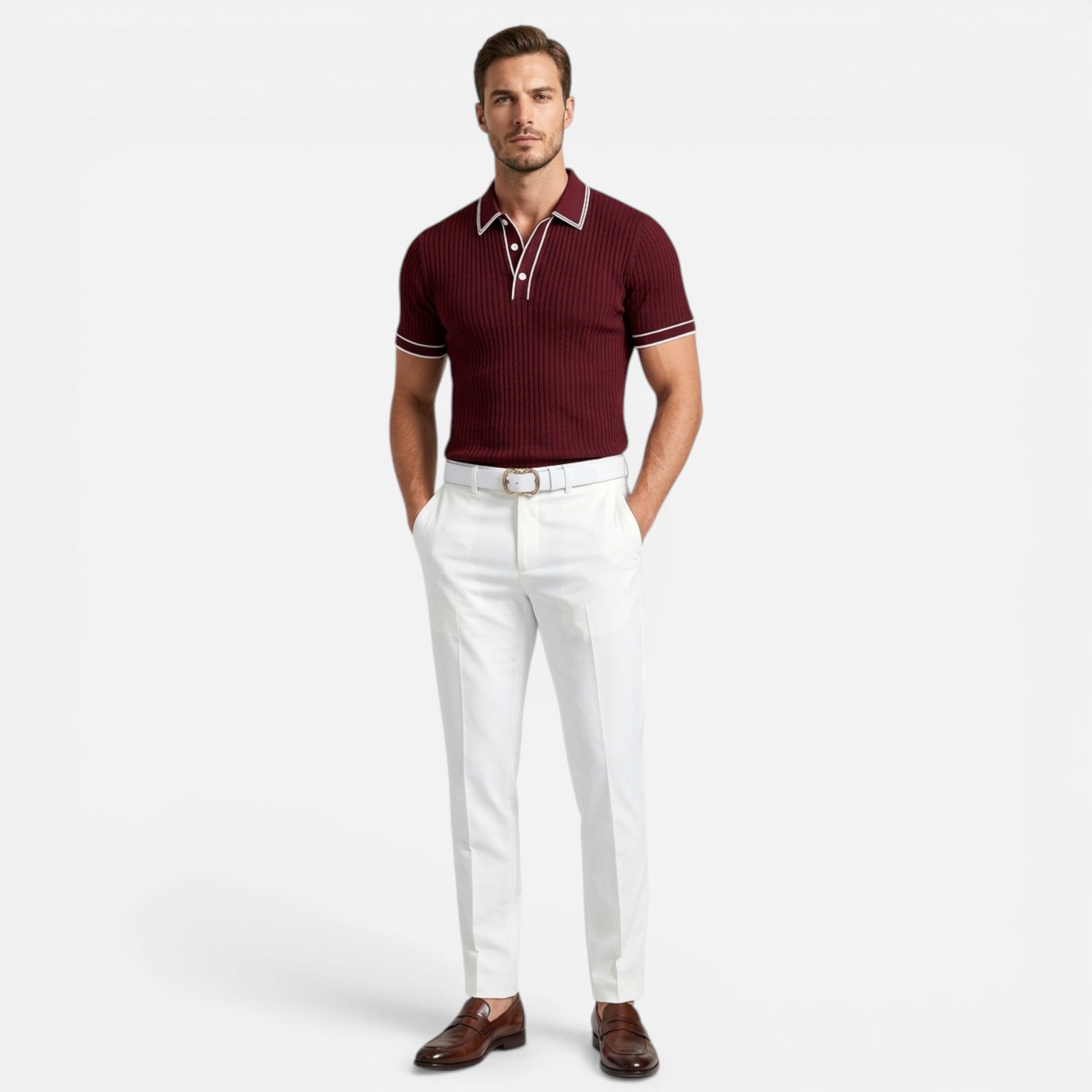 Man wearing a maroon polo shirt and white pants on a light gray background