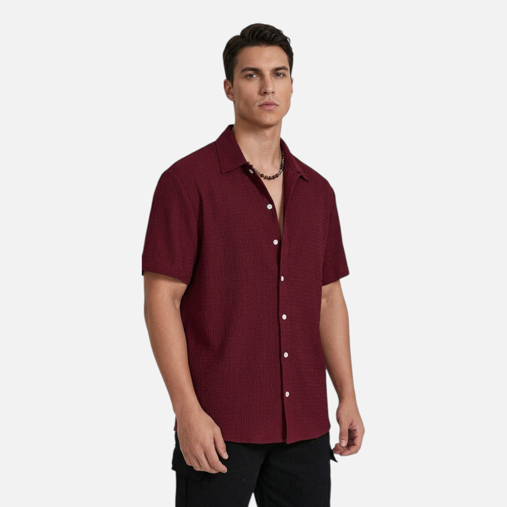 Man wearing a maroon short-sleeve shirt on a white background