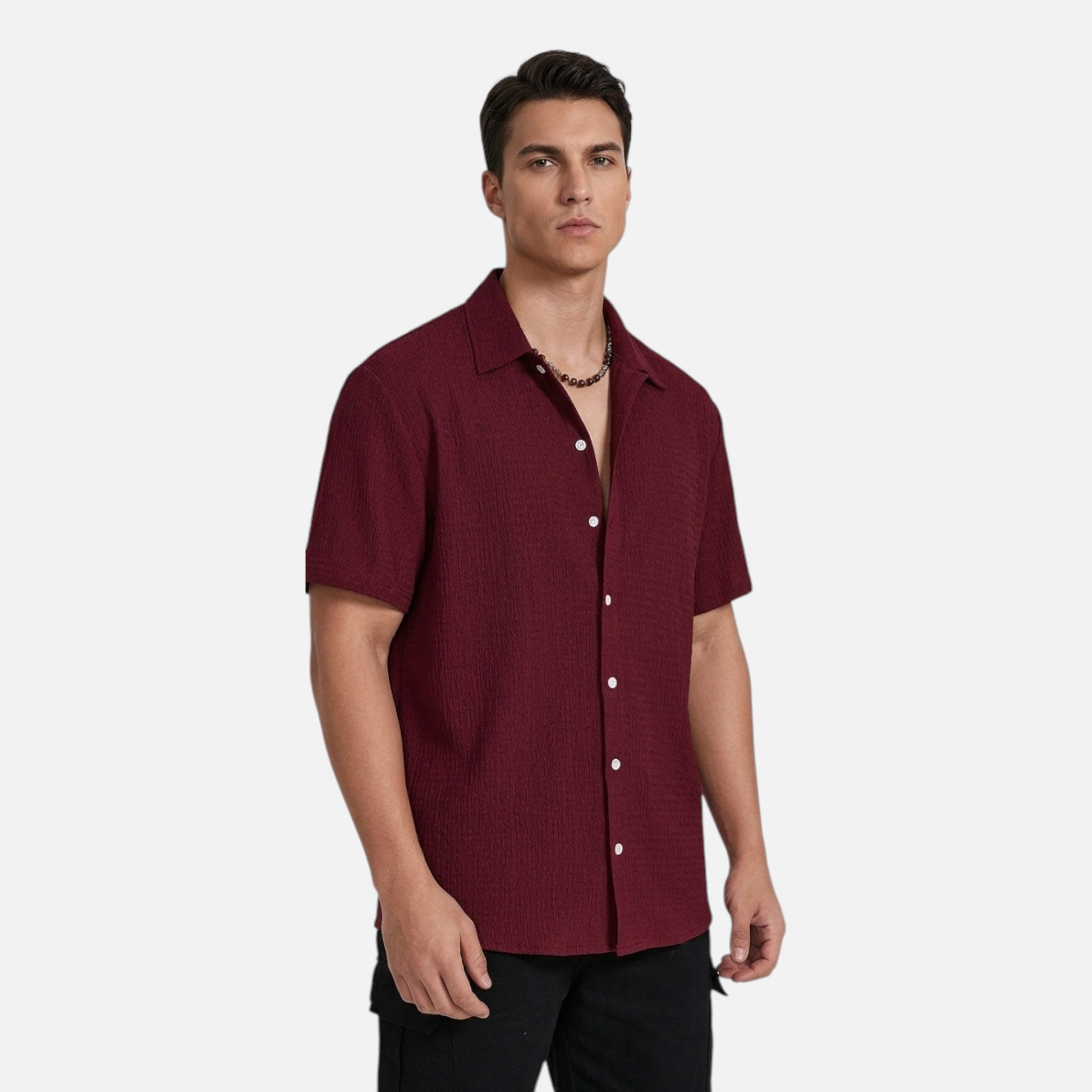 Man wearing a maroon short-sleeve shirt on a white background