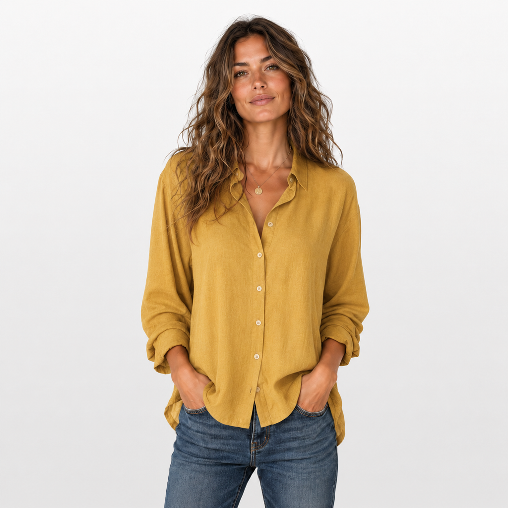 Woman wearing a mustard yellow shirt and blue jeans on a white background