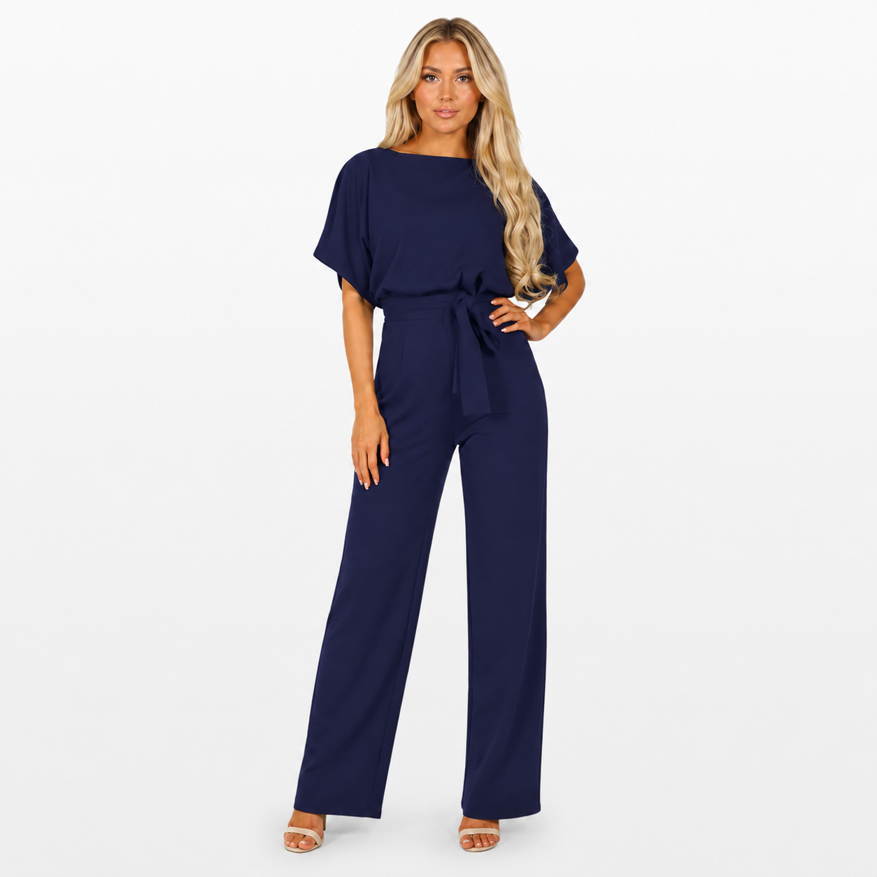 Woman wearing a navy blue jumpsuit on a white background