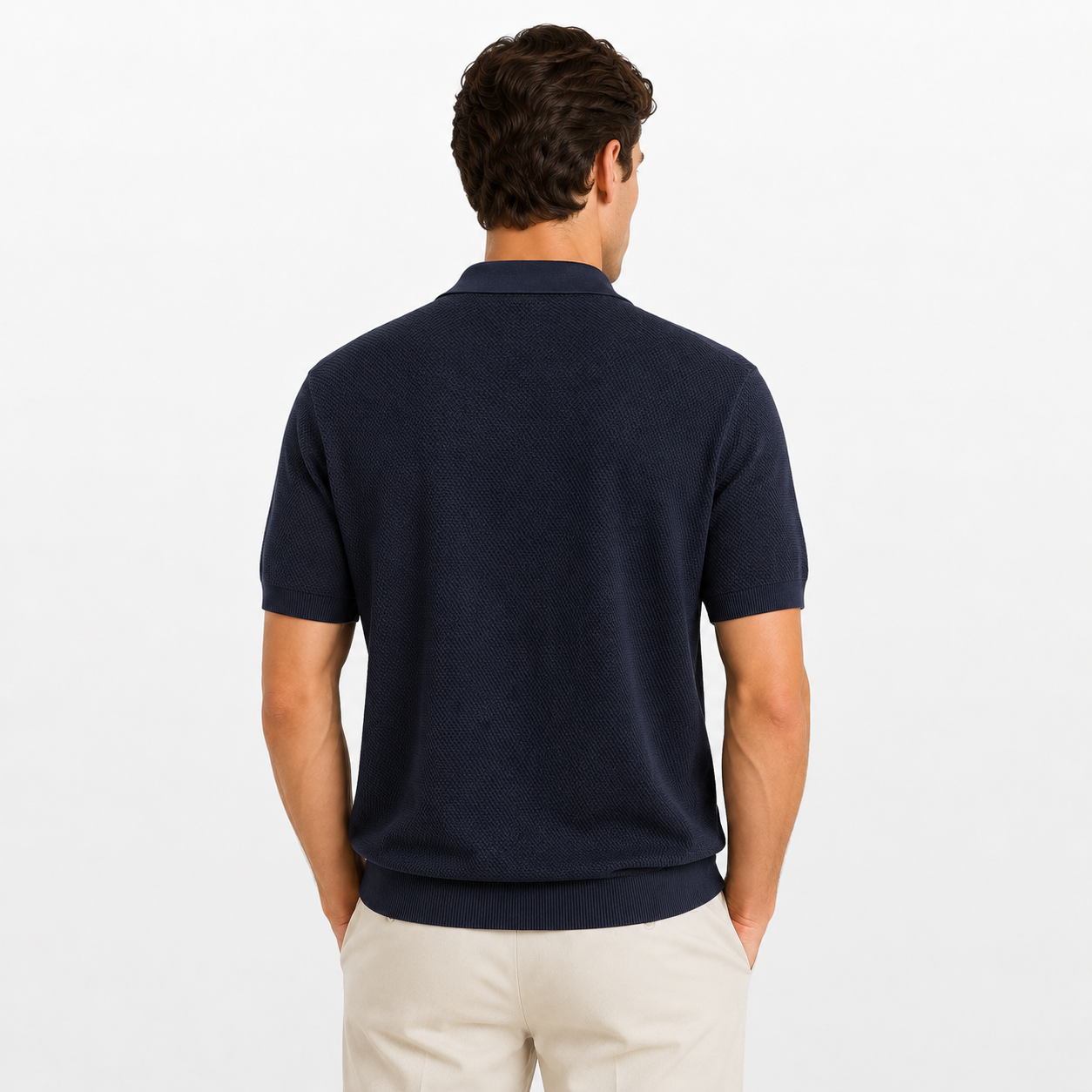 Man wearing a navy blue polo shirt on a white background