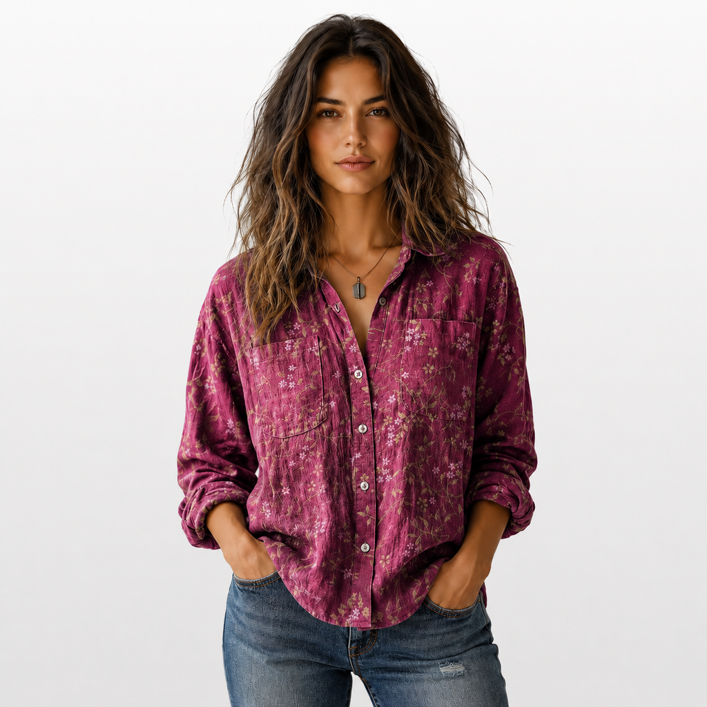 Woman wearing a patterned pink shirt and jeans on a white background