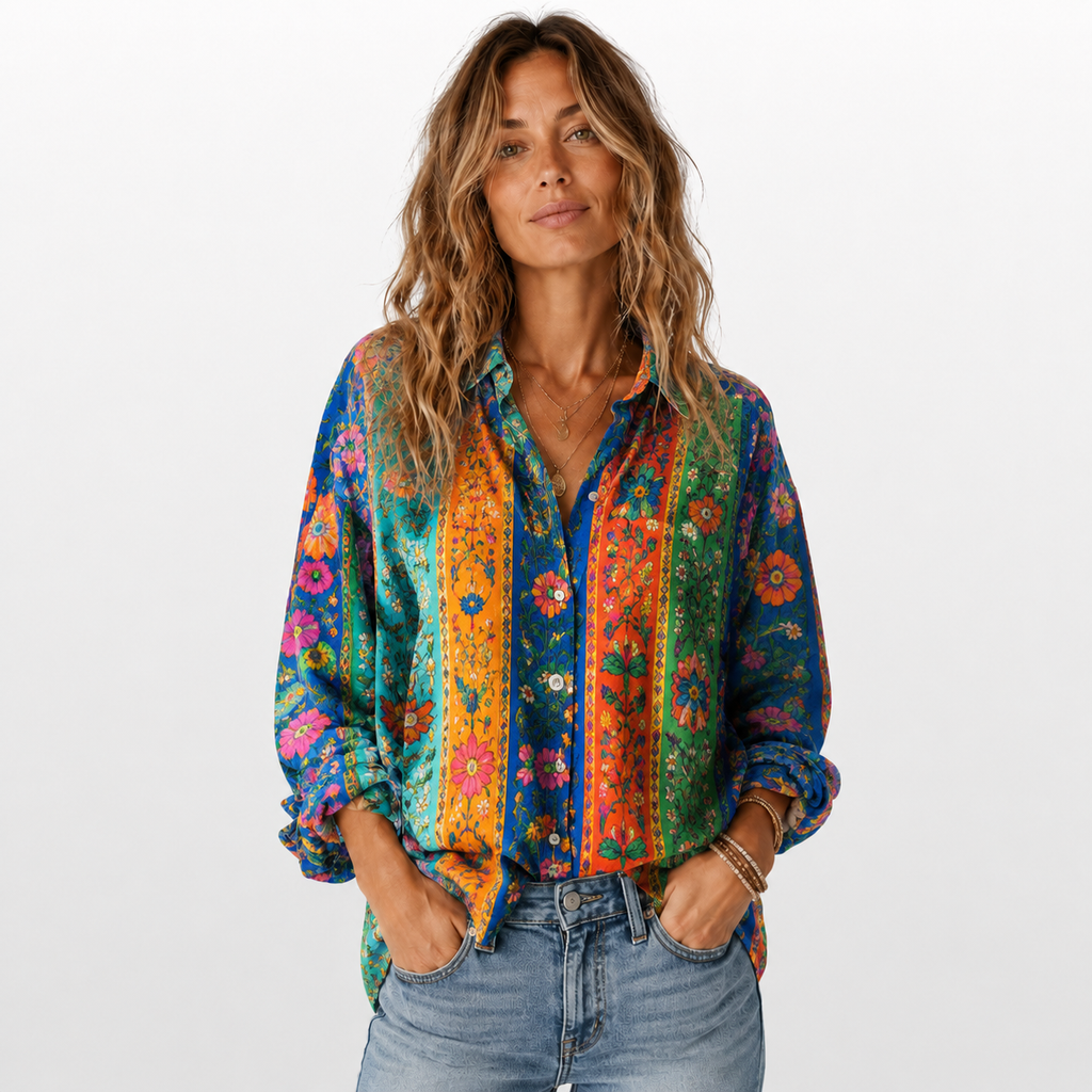 Woman wearing a colorful patterned shirt with a plain background