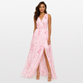 Woman wearing a pink floral dress on a white background
