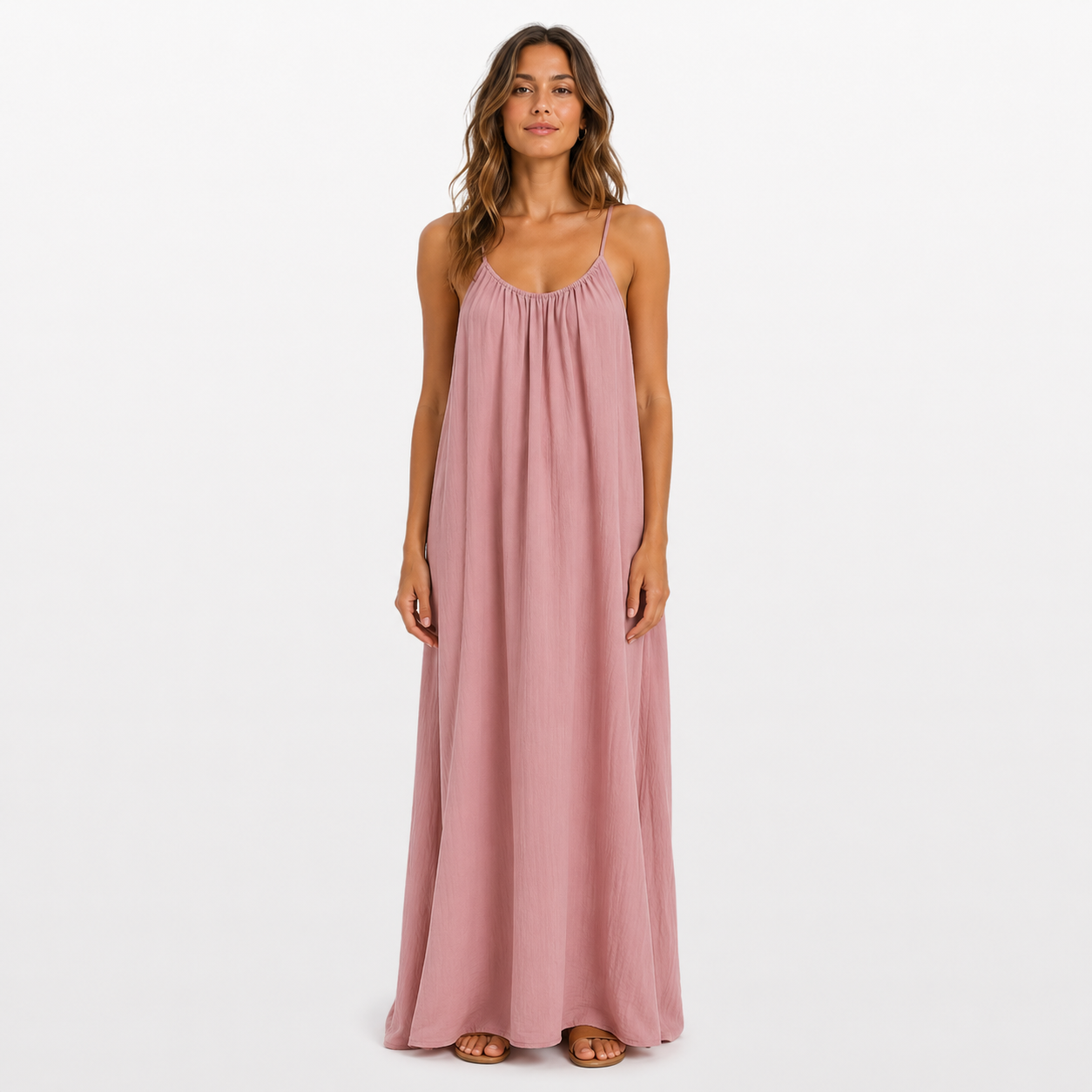 Woman wearing a pink maxi dress on a white background