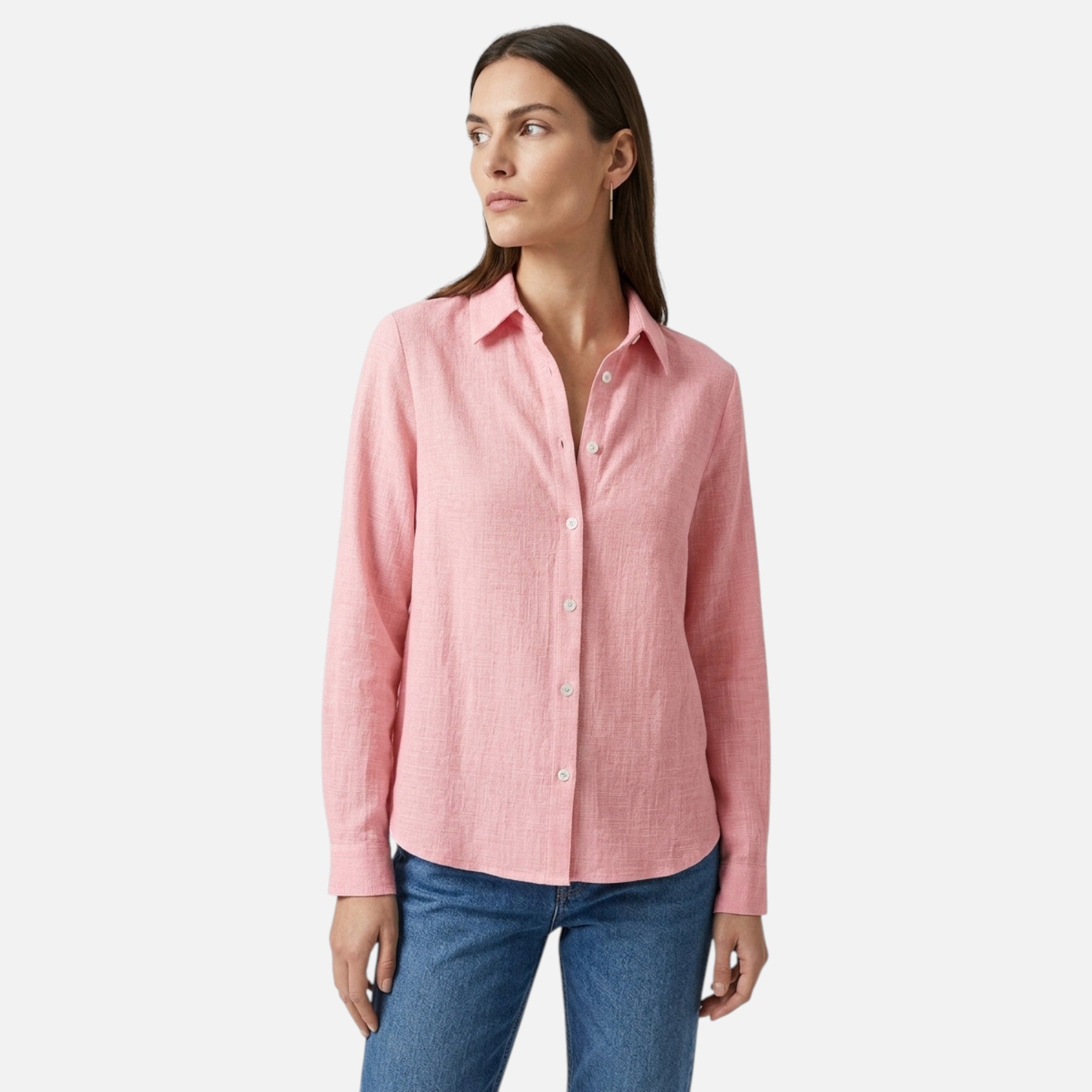 Woman wearing a pink shirt and blue jeans on a white background