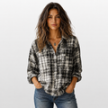Woman wearing a plaid shirt and jeans on a white background