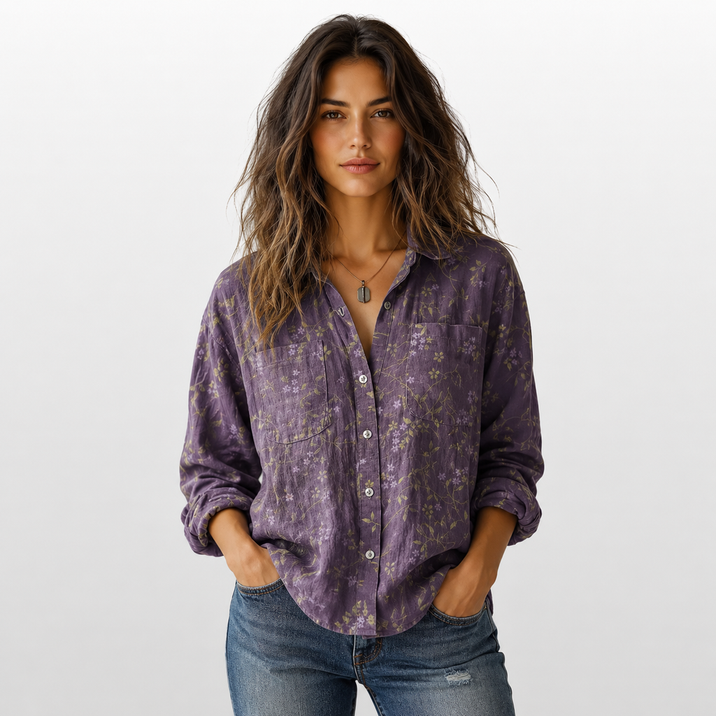 Woman wearing a purple patterned shirt and jeans on a white background