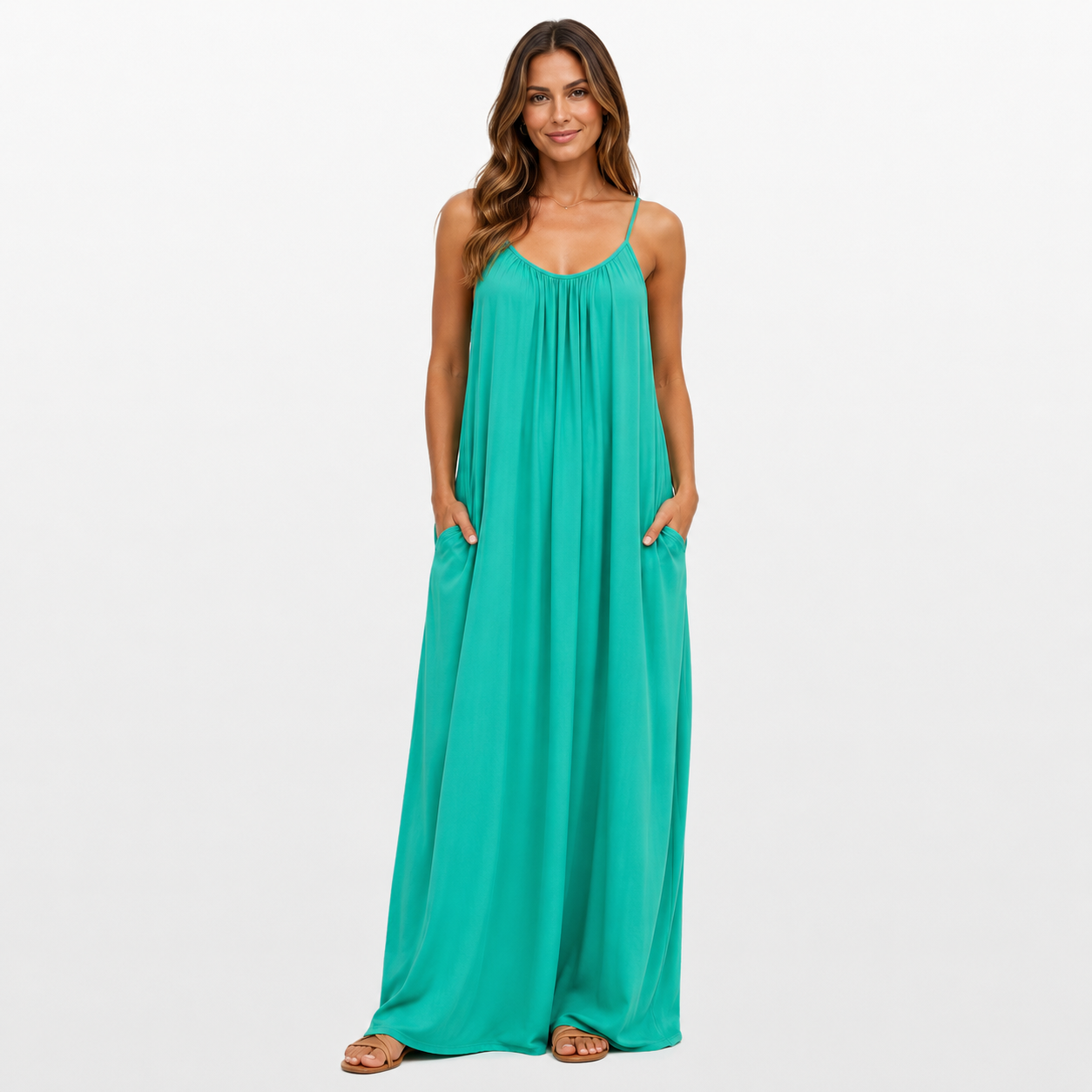 Woman wearing a teal maxi dress on a white background