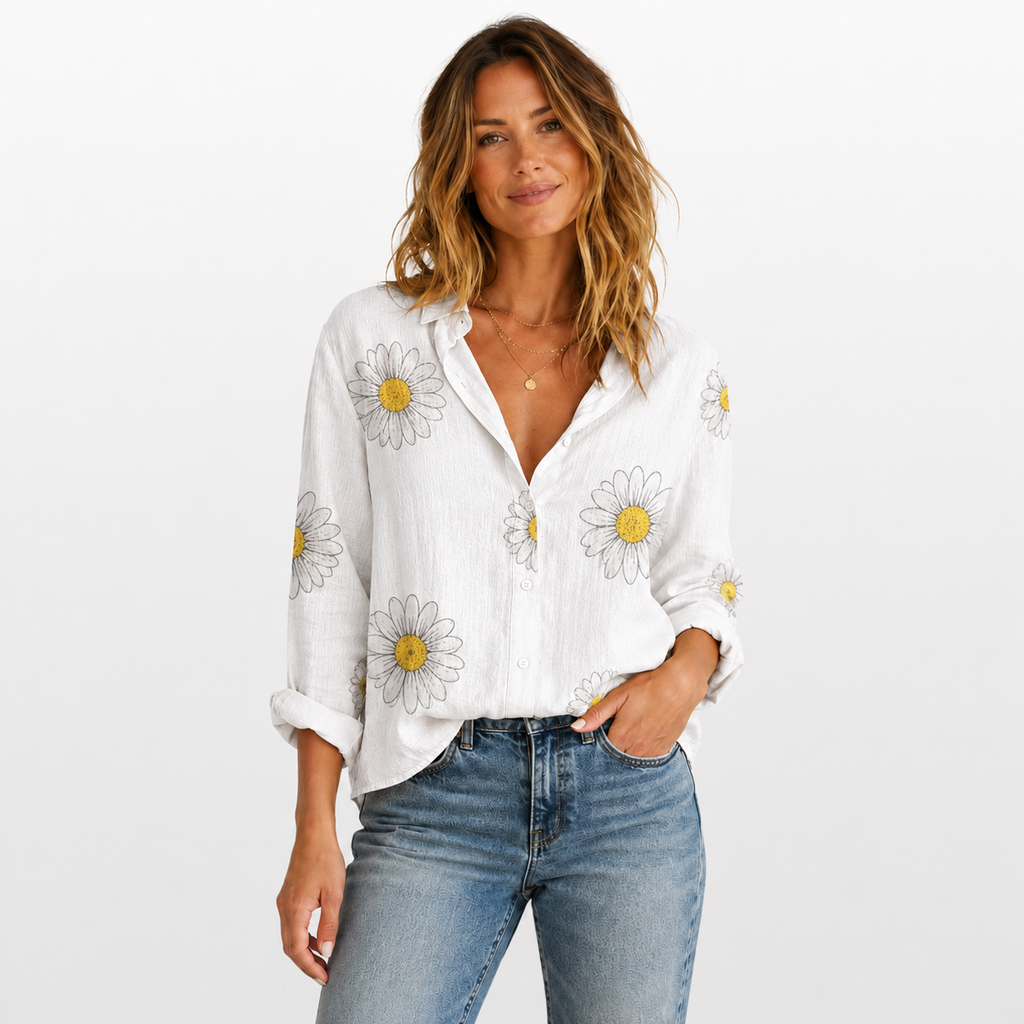 Woman wearing a white blouse with floral patterns and blue jeans on a white background