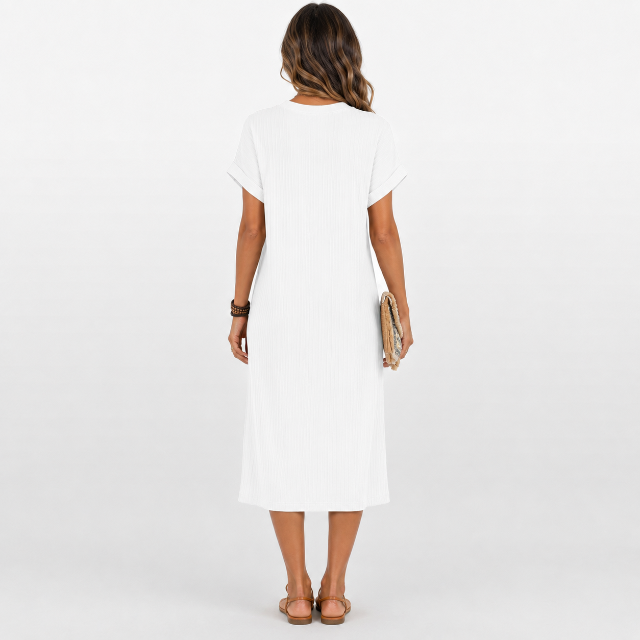 Woman wearing a white dress on a plain background