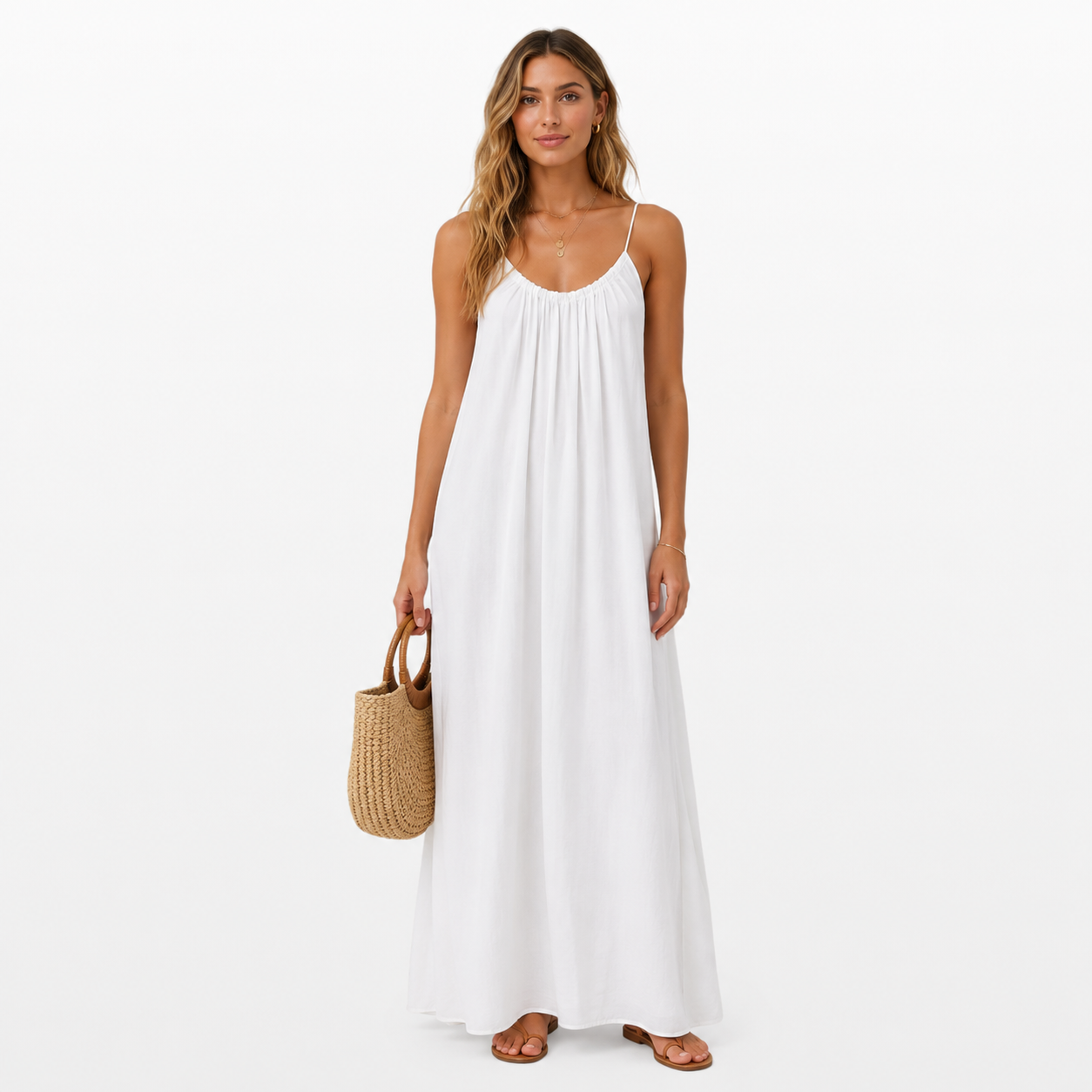 Woman wearing a white dress holding a straw bag on a white background